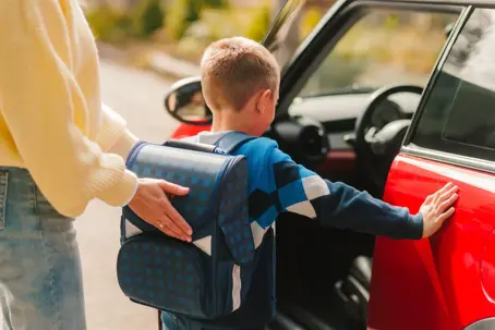 Parent dropping off child at school